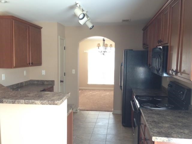 a kitchen with a stove and a refrigerator