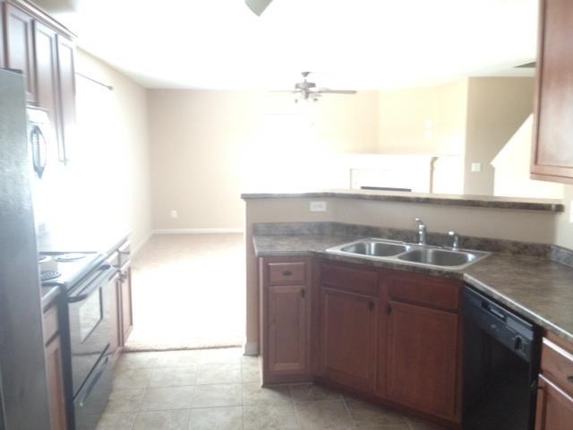an empty kitchen with a sink and a stove