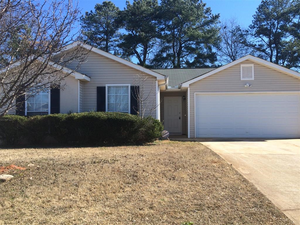 a house with a white garage door and a driveway
