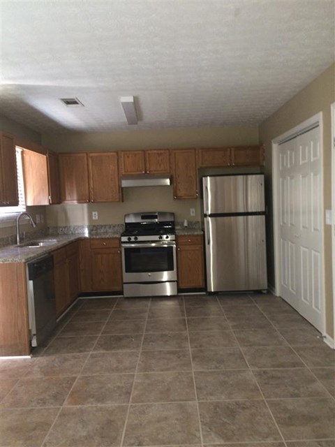 a kitchen with a stove and a refrigerator