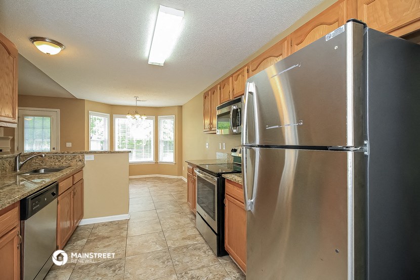 a kitchen with stainless steel appliances and wooden cabinets