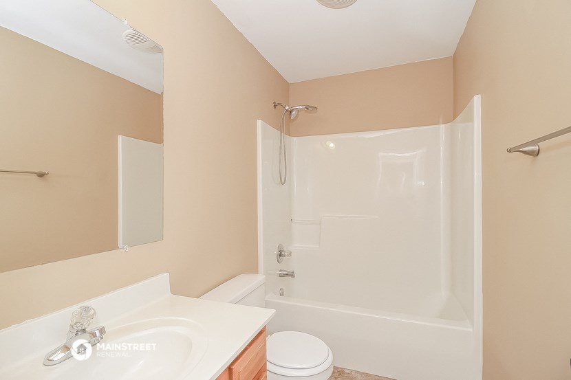 a bathroom with a shower and a sink and a toilet