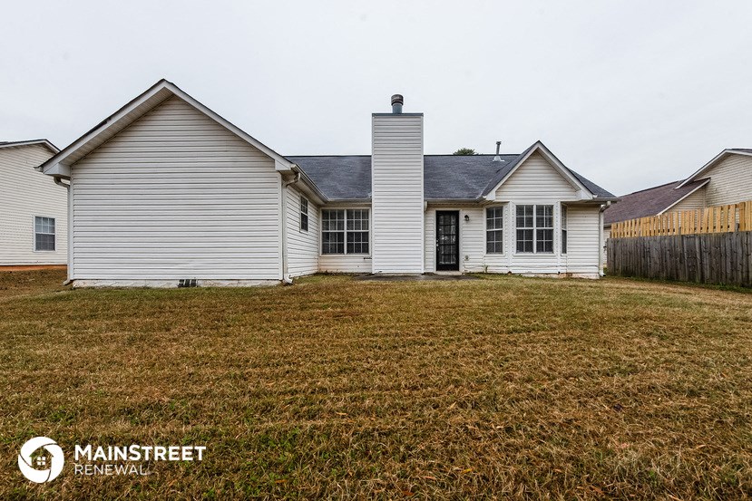 a white house with a yard in front of it