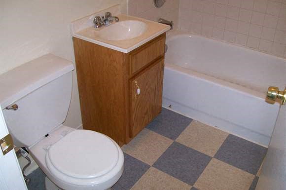 a bathroom with a toilet and a sink and a bath tub