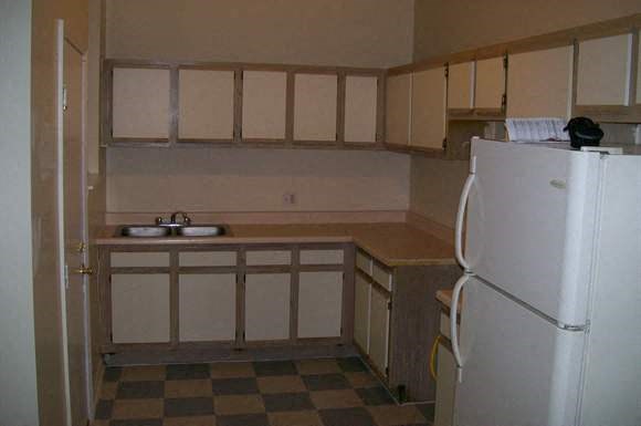 a small kitchen with a sink and a refrigerator