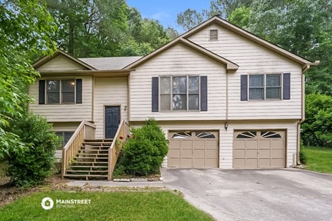 a white house with a garage and a driveway