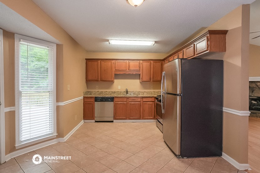 a kitchen with stainless steel appliances and wooden cabinets