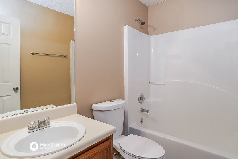 a bathroom with a shower toilet and sink