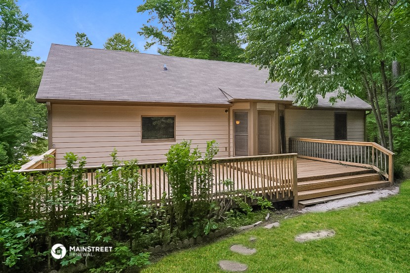 the front of a house with a wooden deck