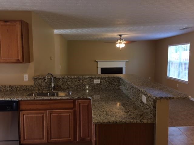 a kitchen with a granite counter top and a sink