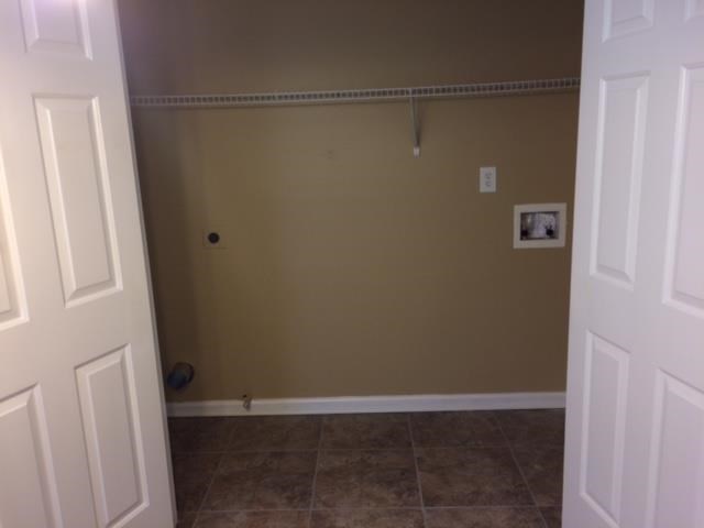 an empty room with a closet and a tiled floor