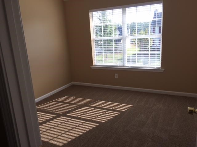 an empty room with a large window and