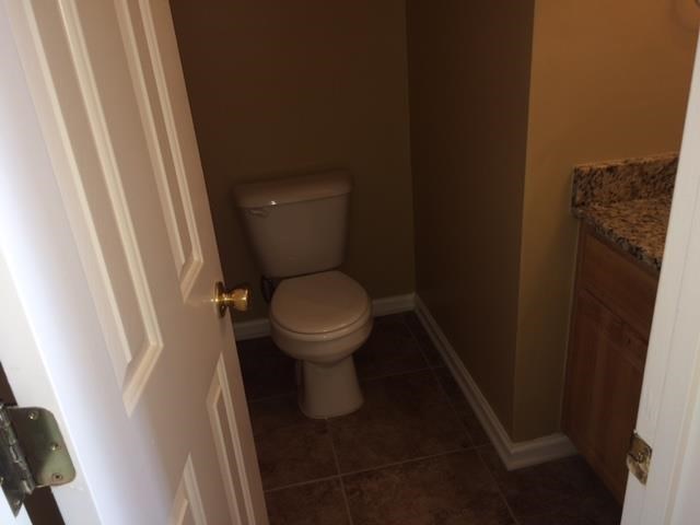 a bathroom with a toilet and a door