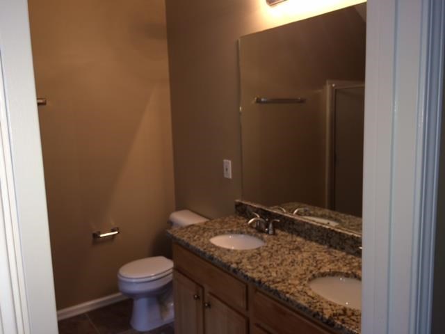 a bathroom with a toilet and a sink and a mirror