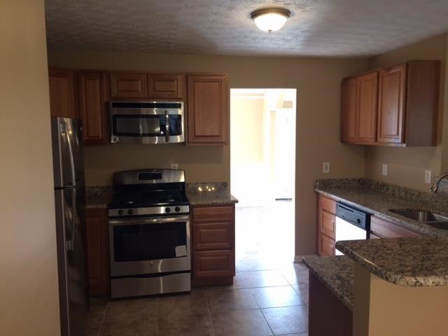 a kitchen with a stove and a refrigerator