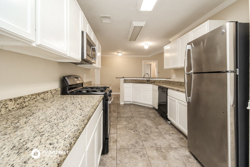 a kitchen with stainless steel appliances and granite counter tops