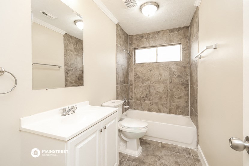 a bathroom with a sink toilet and a shower