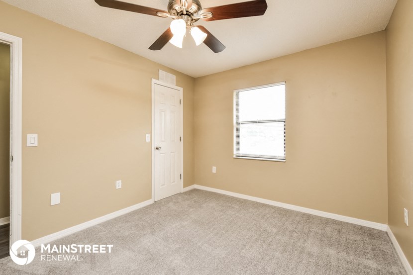 the master bedroom is spacious and has a ceiling fan