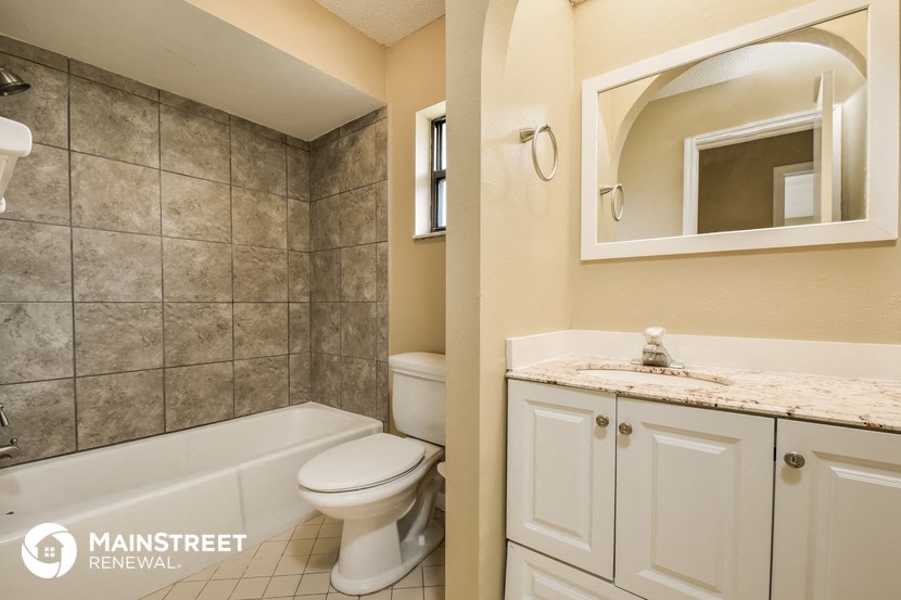 a bathroom with a toilet and a sink and a tub
