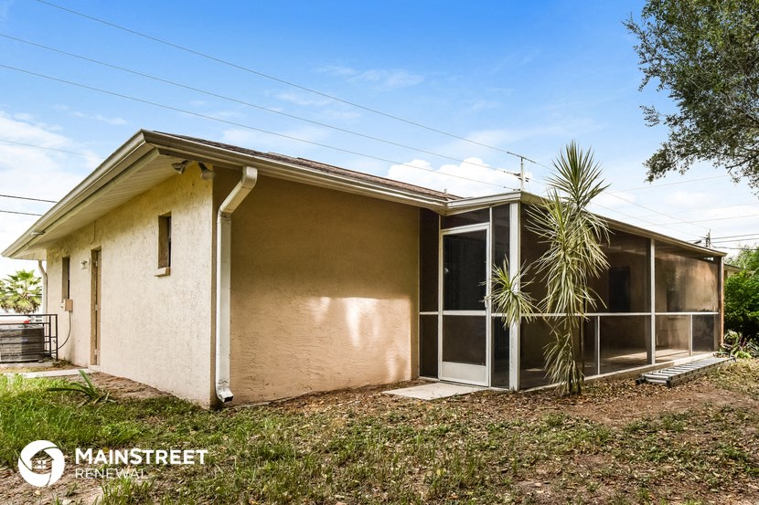 a small house with a palm tree in front of it