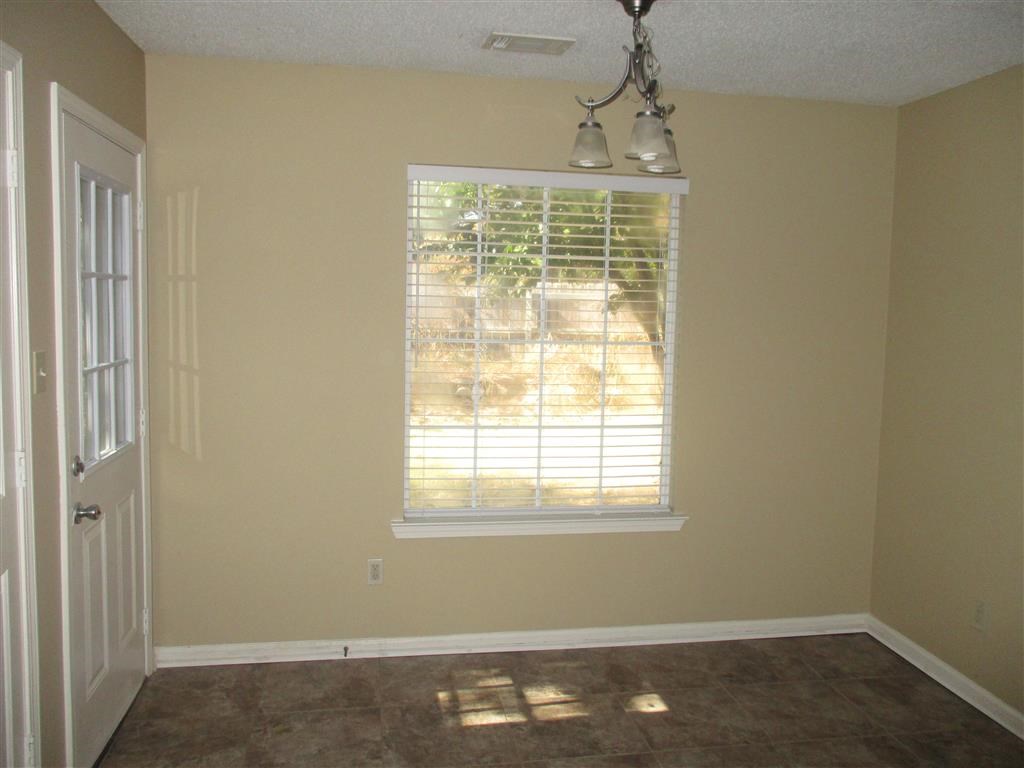 a empty room with a window and a door