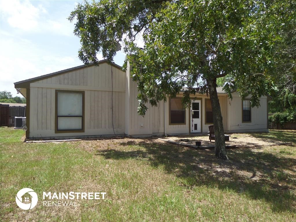 a small house with a tree in front of it
