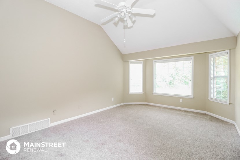 the master bedroom is spacious and has a ceiling fan