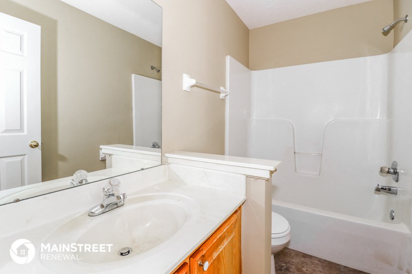 a bathroom with a sink and a toilet and a mirror