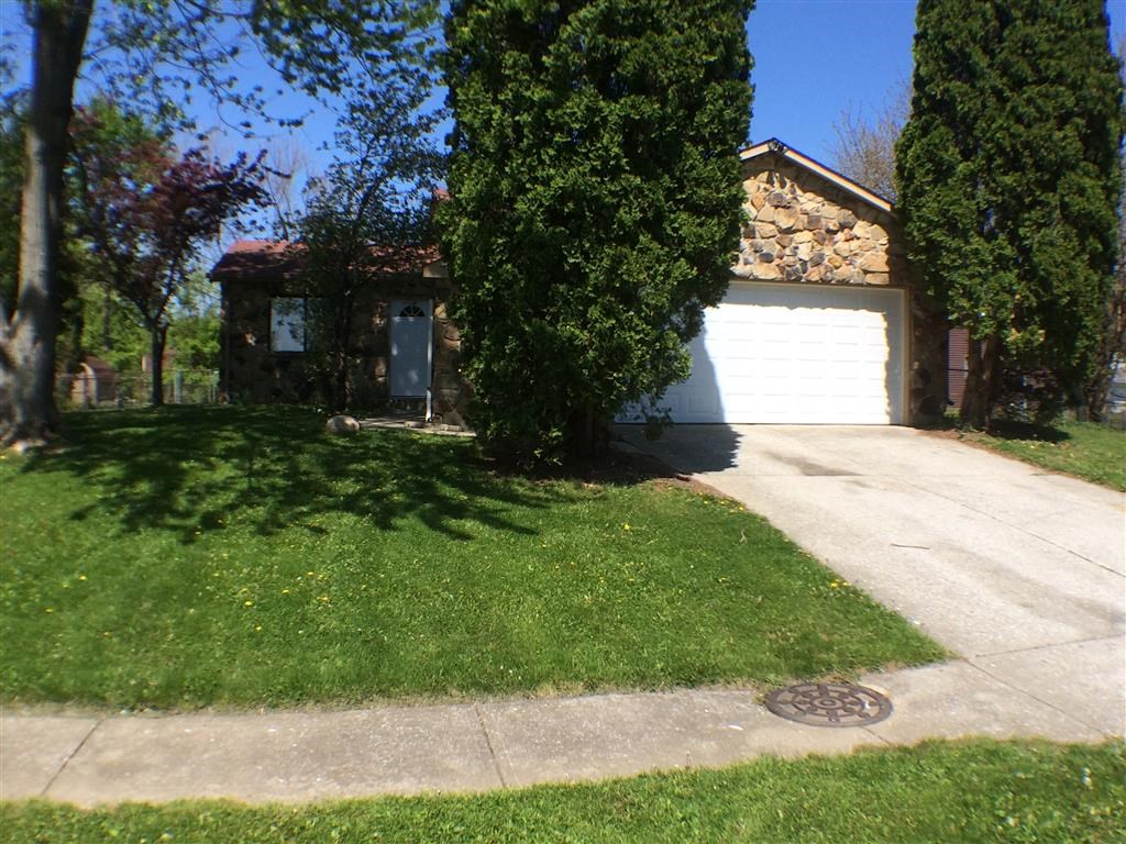 a white garage door in front of a house