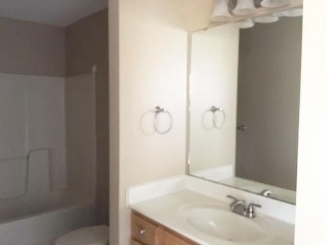 a bathroom with a white sink and a mirror