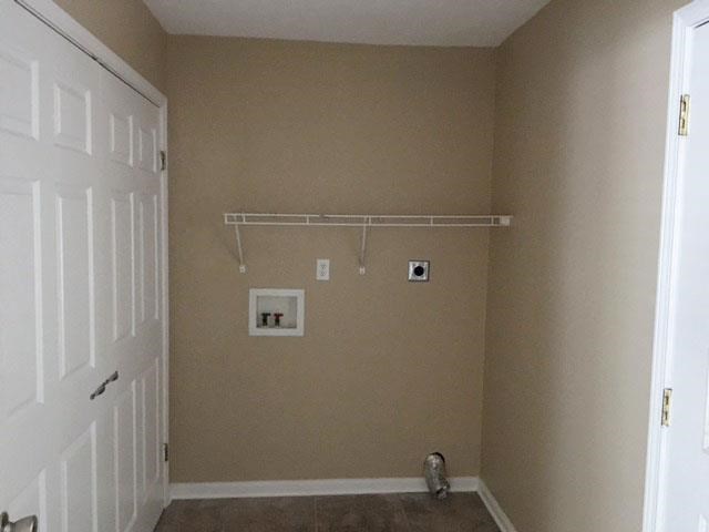 a empty room with a white door and a closet