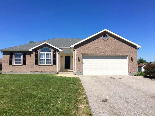 a brick house with a white garage door