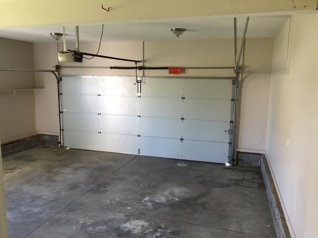 a garage with a white wall and a garage door