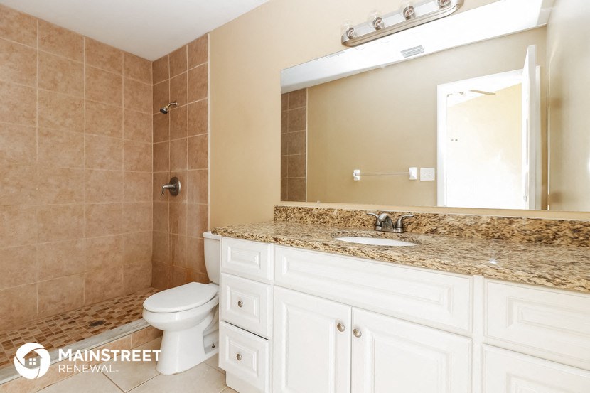 a bathroom with a sink toilet and a mirror