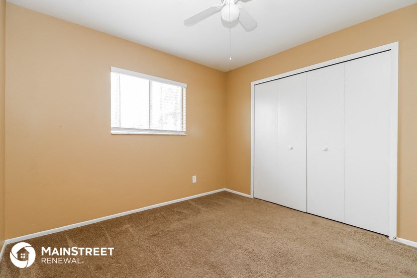 the master bedroom has a large closet and a ceiling fan