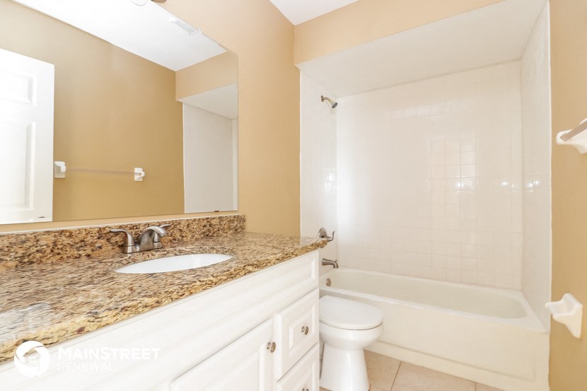 a bathroom with a sink and a toilet and a shower