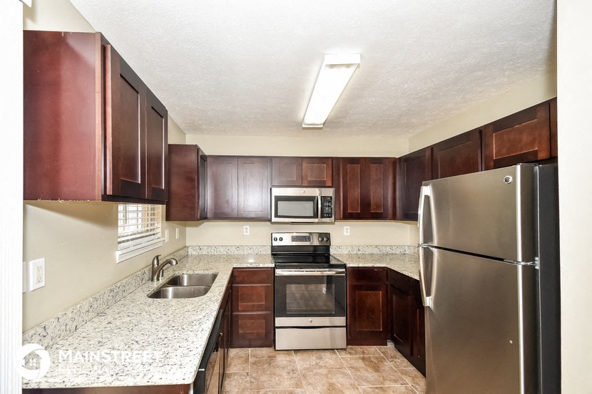 a kitchen with stainless steel appliances and granite counter tops