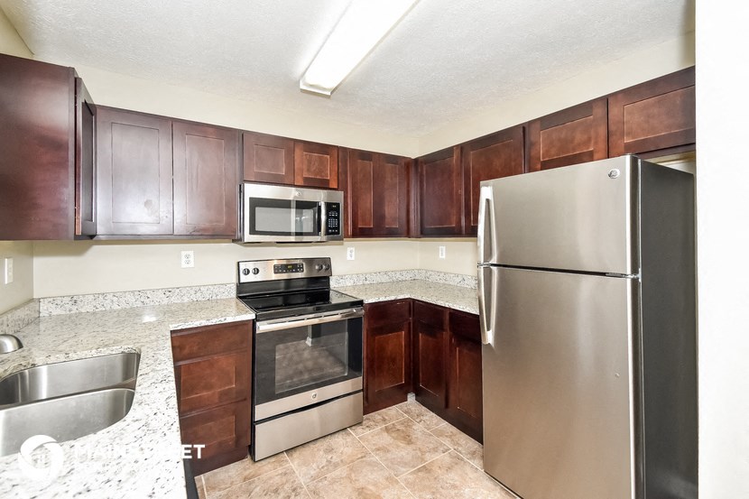 a kitchen with stainless steel appliances and wooden cabinets