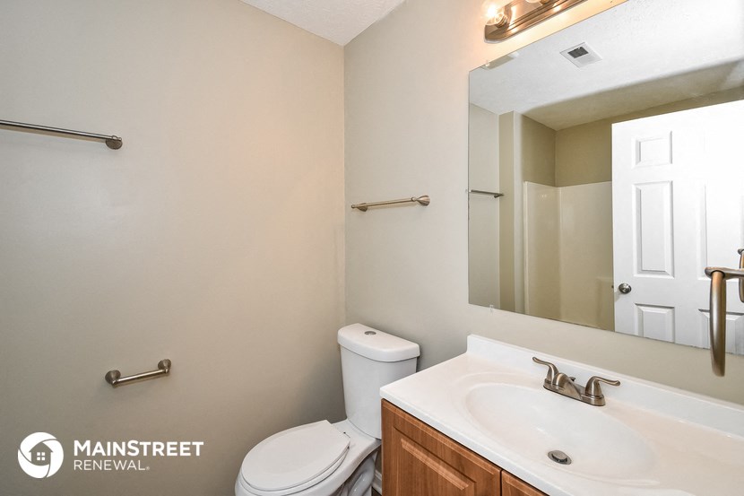 a bathroom with a sink and a toilet and a mirror