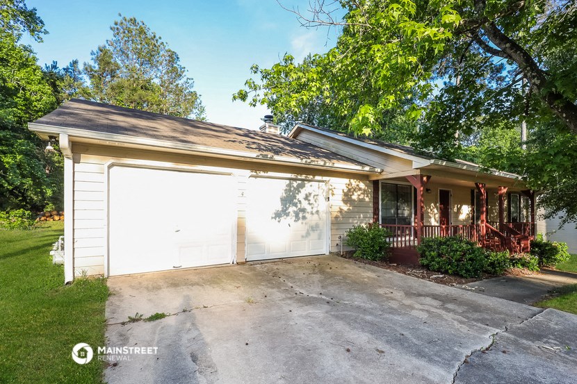 a white house with a driveway and a white garage door