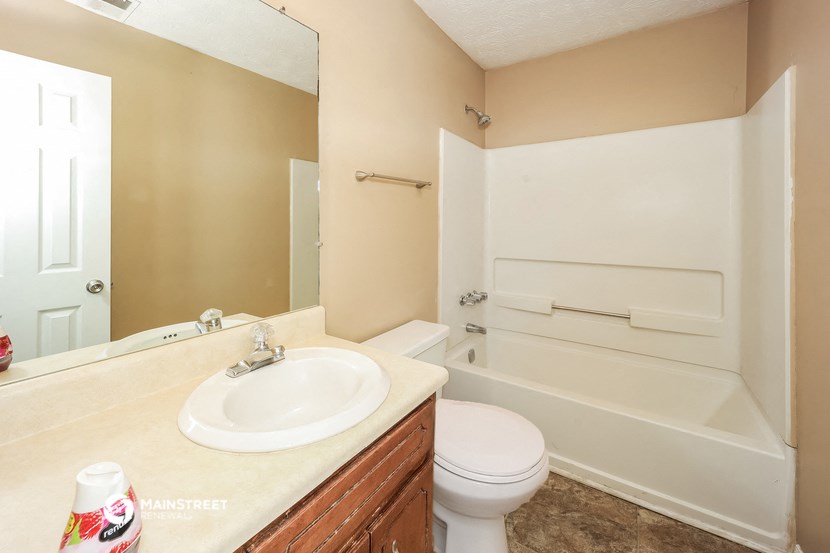 a bathroom with a sink toilet and a bath tub