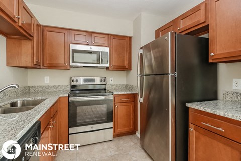 a kitchen with wood cabinets and stainless steel appliances and granite counter tops