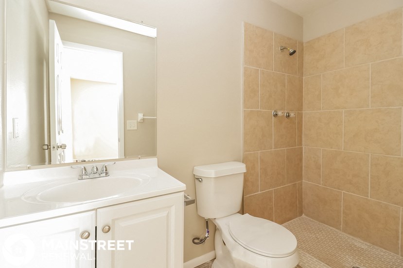 a bathroom with a sink toilet and a mirror