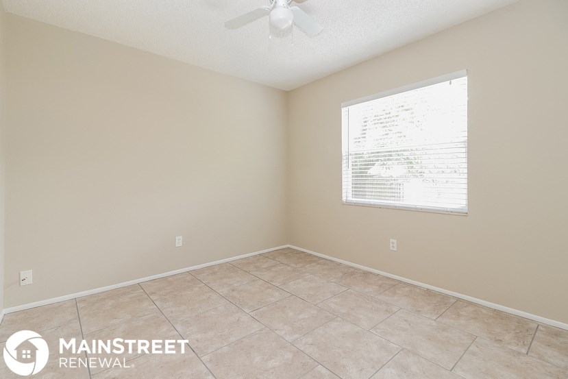 a room with a large window and a tiled floor
