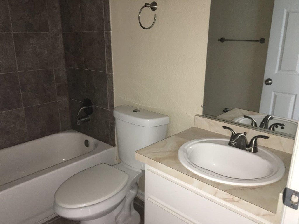 a bathroom with a sink toilet and a bath tub