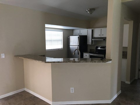 a kitchen with a counter top and a refrigerator