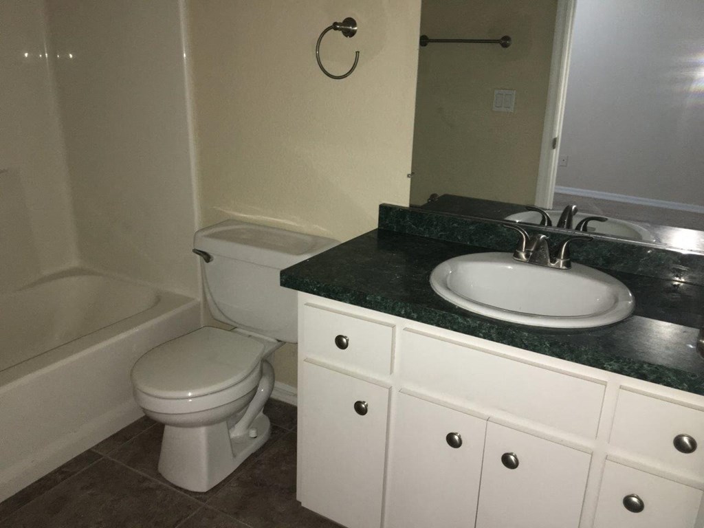 a bathroom with a sink toilet and a bath tub