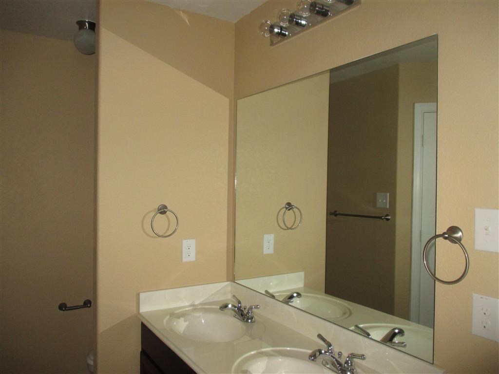 a bathroom with two sinks and a large mirror