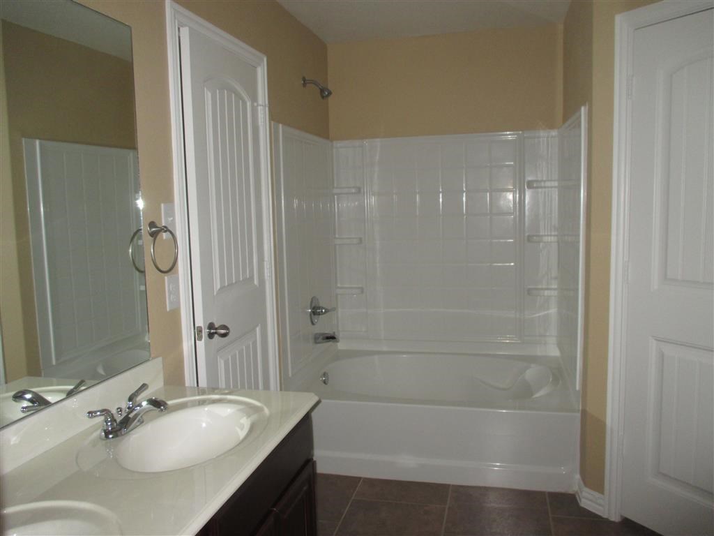 a bathroom with a sink and a tub and a shower