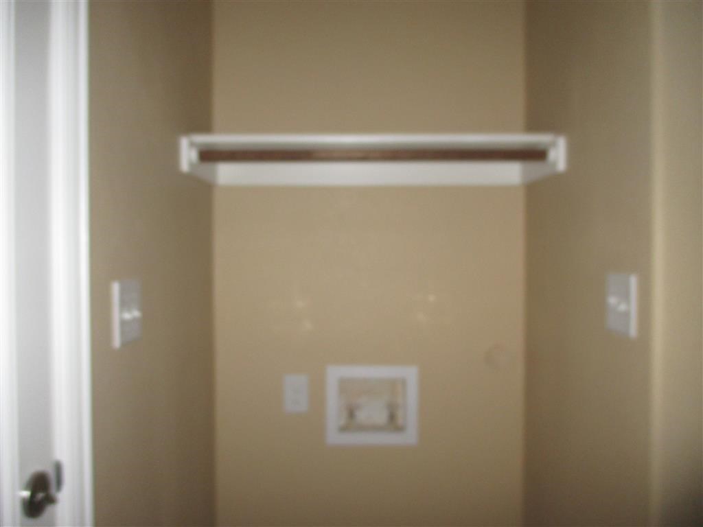 an open bathroom door with a sensor on the wall